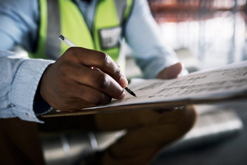 man architect hands writing checklist inventory inspection construction paperwork site hand male contractor working documents planning architecture idea strategy scaled