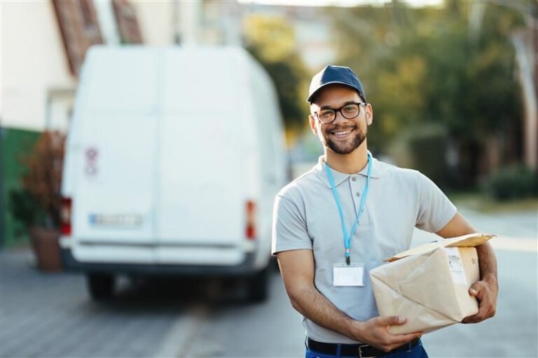 Portrait of Young Happy Courier with Packages for a Delivery